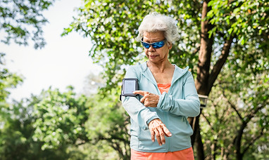 senior-runner-using-fitness-tracker.jpg