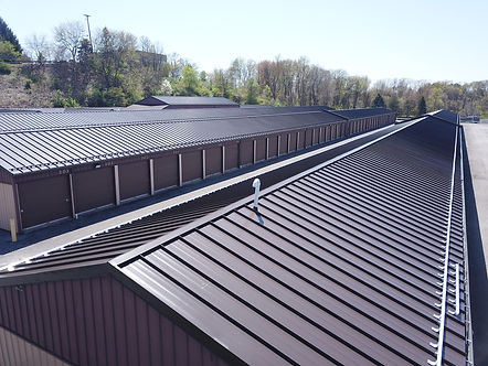 brown standing seam metal roof on a storage faclity