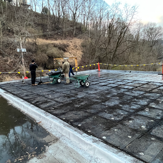 roofers prepping a flat roof to install a new flat roof