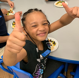 Youth Chef Academy Primary student giving a big thumbs ups and smile