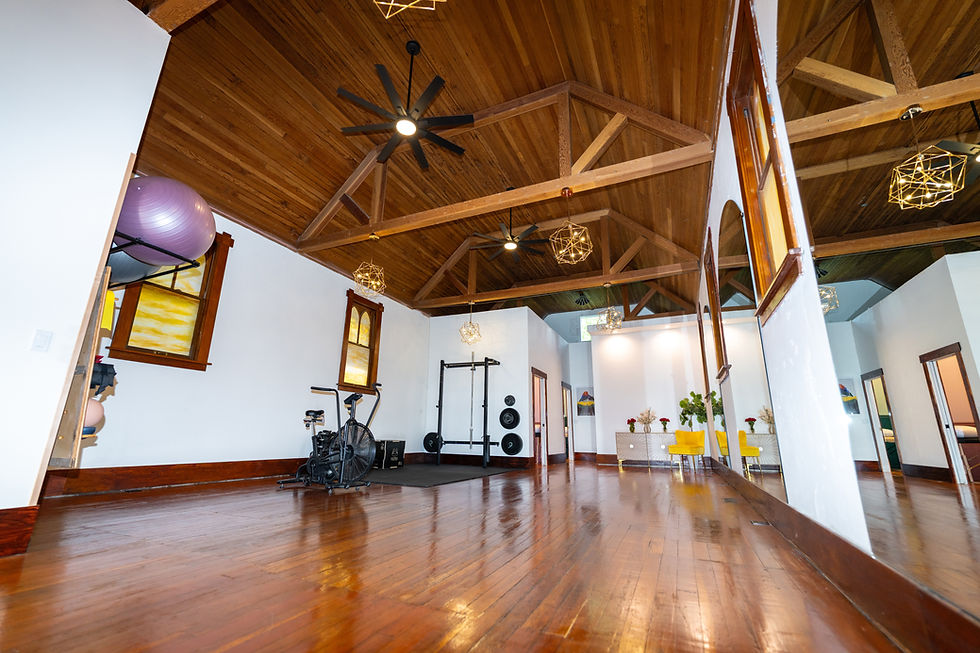 A view of the interior of Glacier Peaks Phsical Therapy's studio from a bottom corner. Featuring an exercise bike, exercise balls, a beautiful wood floor and other exercise equipment