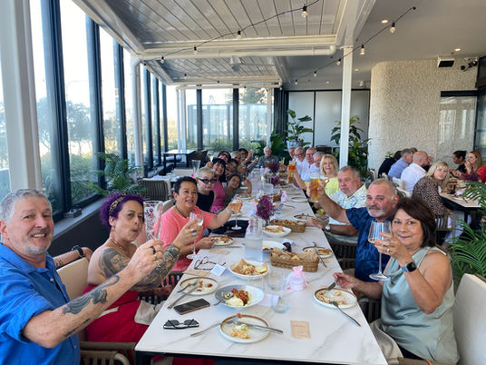 Group of guests toasting during a private function on the balcony at La Calabrese, Surfers Paradise