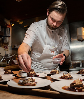 Chef plating food for guests – commercial and corporate photography