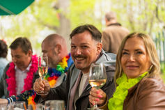 Happy guests raising a toast at a summer party – event photography