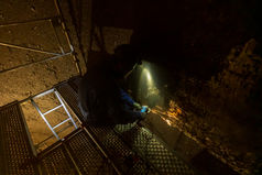 Inspection inside a large tank with work lights – industrial photography