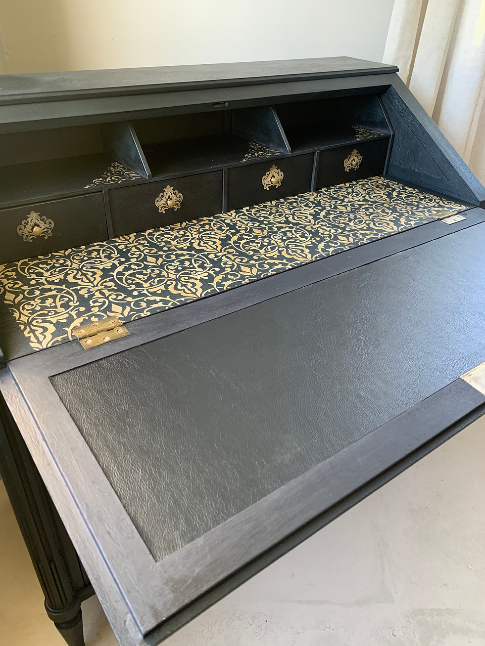 Miniature : Création de meuble unique en bois massif. Un bureau secrétaire d'époque restauré et décoré avec application d'ornements, de pochoirs, sur l'extérieur et l'intérieur du meuble. Meuble en bois massif avec ornements et poignées enduits de feuille dorée ainsi qu'une patine dorée réalisée sur l'ensemble du meuble pour un parfait relooking de meuble