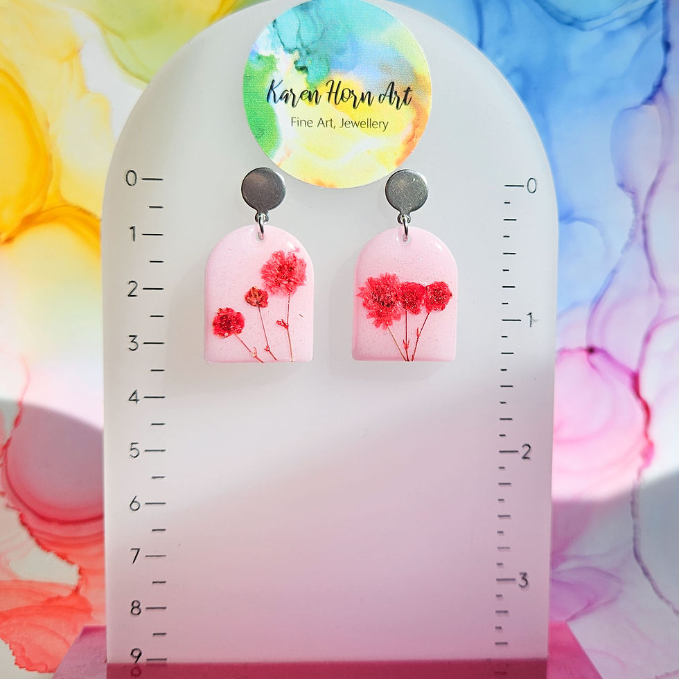 Thumbnail: Handmade drop resin earrings with encased red dried flowers, black or pink