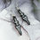 Thumbnail: Handmade black resin skull and sword earrings