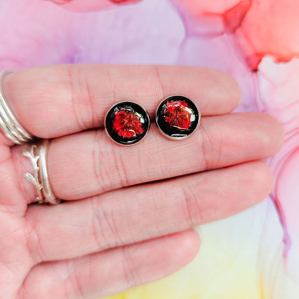 Thumbnail: Handmade resin stud earrings with encased red pressed dried flower