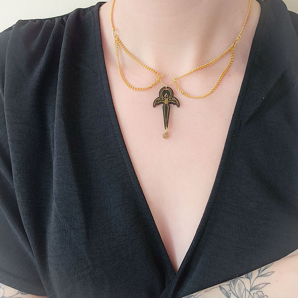 Thumbnail: Handmade soft gothic dagger resin pendant on a golden stainless steel chain