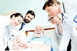 4 health professionals with a patient in a hospital setup