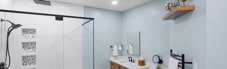 This luxury master bath renovation in Glen Allen completely transformed a dark, cluttered layout into a breathtaking mid-century modern spa retreat. Featuring a custom makeup station, hardwired heated towel racks, and beautiful Showplace Hickory cabinetry in a rich Cognac finish, every detail was designed for the ultimate 5-star hotel experience at home.