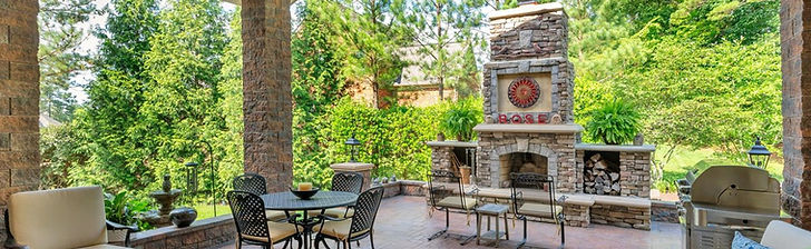 To solve the problem of an exposed patio that was unusable in bad weather, we designed and built a high-end covered porch with brick columns and a custom roof that looked original to the home. This award-winning transformation required complex engineering, including a massive steel I-beam for an open view and a unique 3-foot roof extension to safely clear the existing fireplace.