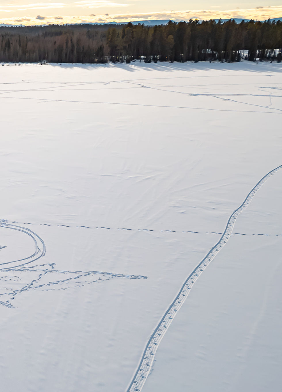 Ice fishing tent on a large frozen snow covered lake in Alberta.jpg
