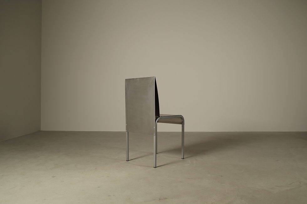 Thumbnail: Rear three-quarter studio composition of a single brushed aluminium dining chair with curved metal seat frame.