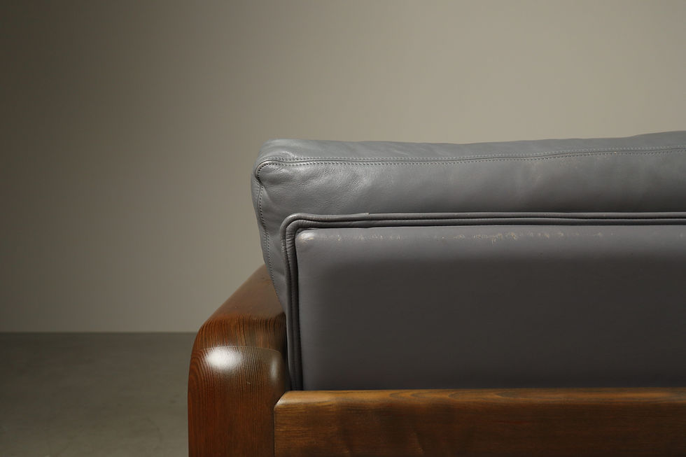 Thumbnail: Close-up composition of grey leather back cushions within the rounded wooden Rosenthal Hombre frame.