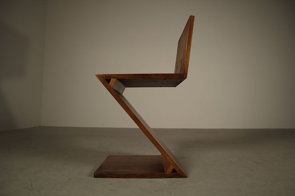 Thumbnail: Full side view of handcrafted wooden Zig-Zag chair highlighting cantilevered geometry and triangular joint reinforcements.