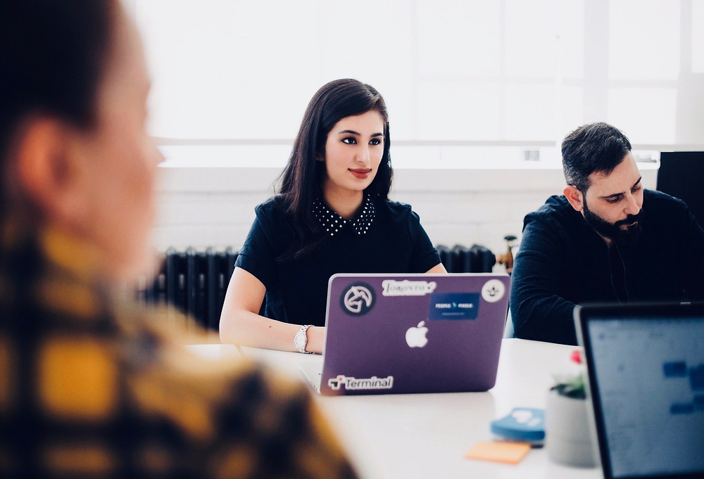 People in a team meeting with laptops