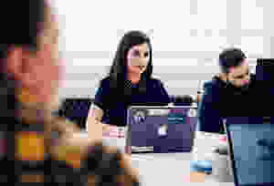 People in a team meeting with laptops