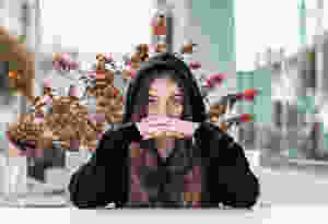 Pretty young brunette woman wearing black hoodie.