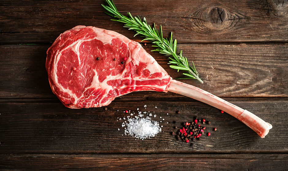 raw Tomahawk steak on wooden background