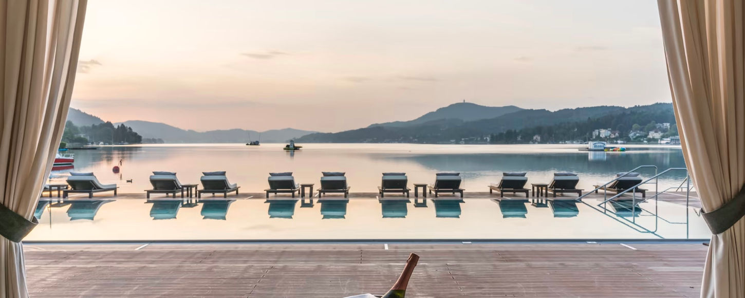 Infinity pool at Schloss Velden on Lake Wörthersee at dusk