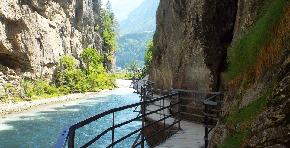 Aare Gorge walkway carved into cliffs above turquoise river in Switzerland