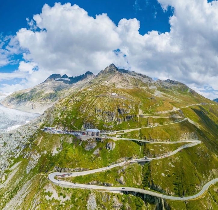 Furka Pass hairpin road with glacier and alpine mountains in the Swiss Alps