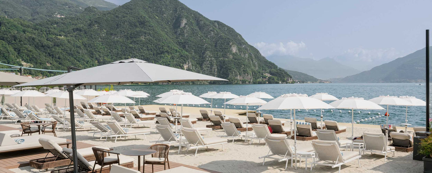 Private beach area on Lake Como with loungers and umbrellas
