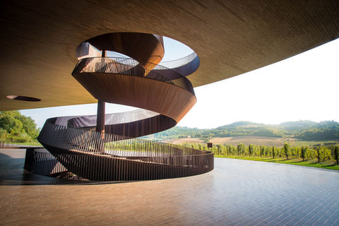 Modern spiral staircase overlooking vineyards at Antinori Winery in Tuscany