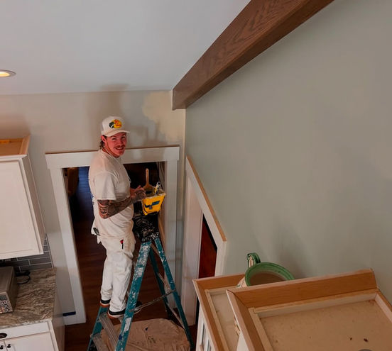 Professional interior painter working on a residential wall repaint in an Asheville home