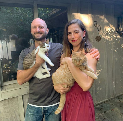 Owners of Interior Painting of Ashville holding their cats while outside of their home