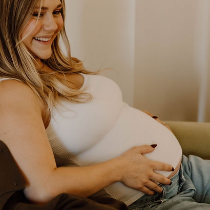 Happy pregnant mom receiving prenatal chiropractic care at Soma Chiropractic in Delray Beach