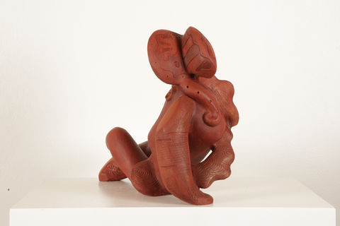 This is a stylize sculpture made out of terra-cotta.