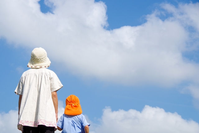 親子が空を見る写真