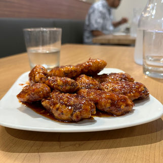 Korean fried chicken wings glazed in a special Ireh sauce, served hot with a golden, crispy coating and a sticky, sweet-savory finish 이레 치켄 