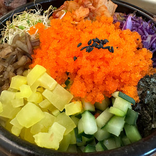 Korean Al Bap bibimbap in a hot earthenware pot, featuring a mix of vibrant vegetables, spicy kimchi, clover sprouts, strips of nori, and bright orange tobiko, with a crispy rice layer at the bottom 알밥