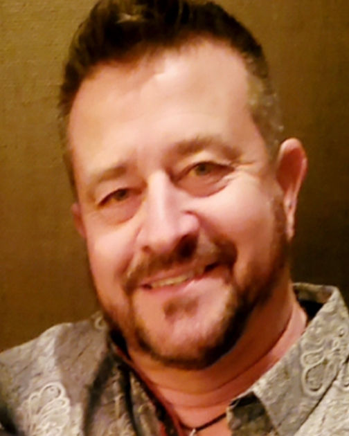 Smiling middle-aged man with a goatee and short dark hair