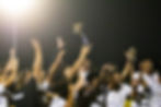 a cheering team holds up a trophy