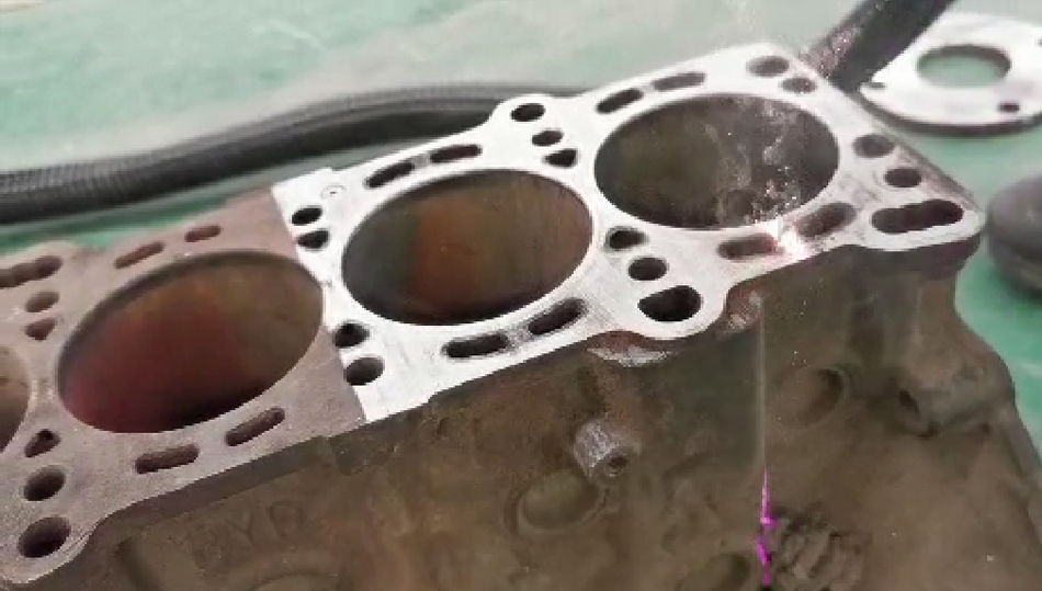 Laser cleaning Geelong services on a rusty engine block.