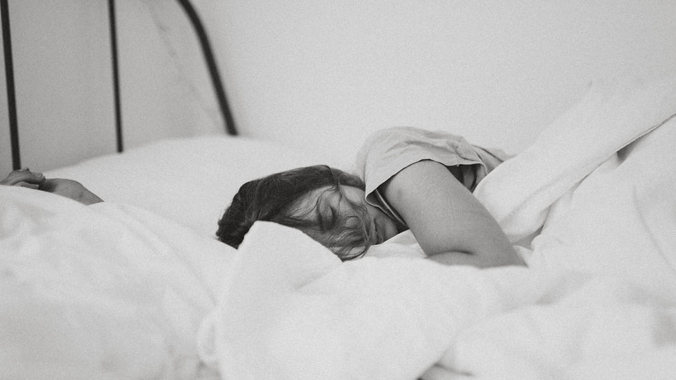Woman lying in bed - representing the forced stillness and self-reckoning that came during the pandemic years of living with endometriosis