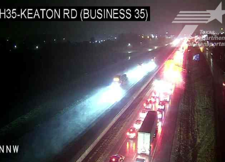 TxDOT traffic camera still of I-35 in Sanger showing emergency response lights and traffic backup after early Thursday collision