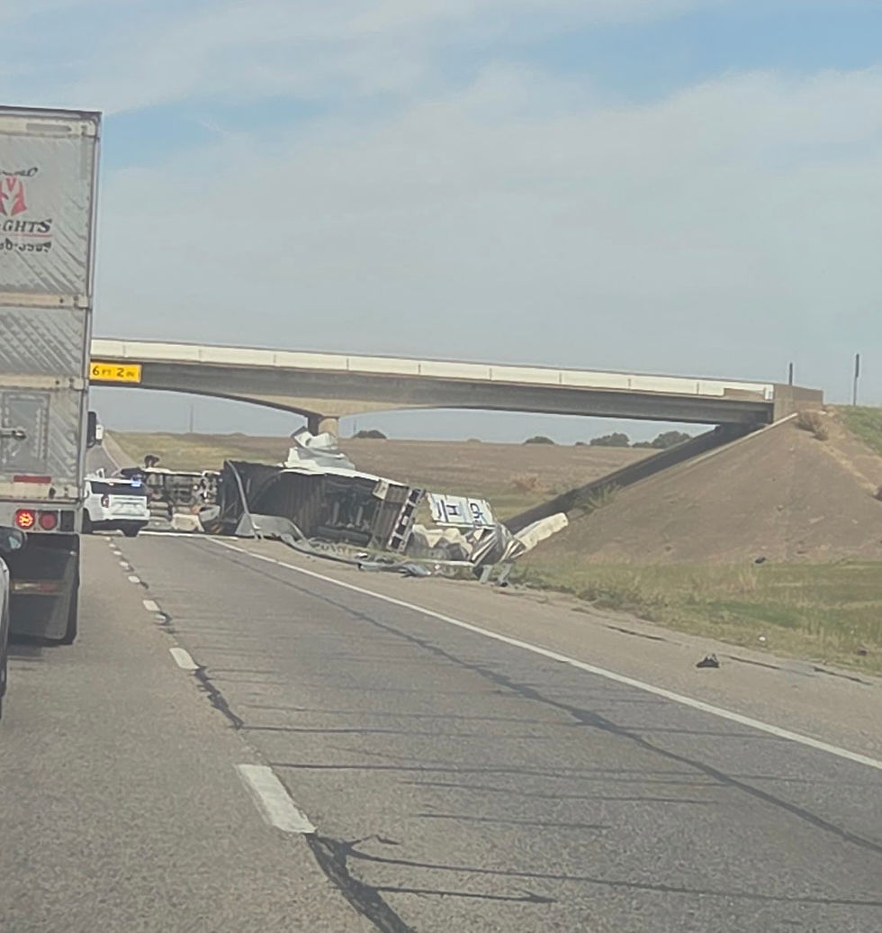 Overturned semi truck and trailer debris beside northbound I-35W under an overpass near Itasca, with a patrol vehicle at the scene. Photo via @dfwscanner.