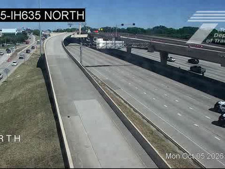 TxDOT traffic camera view of US 75 at I-635 in North Dallas showing Dallas police vehicles on an emptied stretch of freeway Monday afternoon after a fatal crash