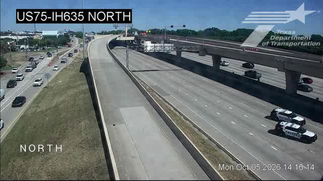TxDOT traffic camera view of US 75 at I-635 in North Dallas showing Dallas police vehicles on an emptied stretch of freeway Monday afternoon after a fatal crash