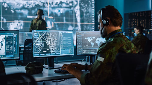 Military Surveillance Officer Working on a City Tracking Operation in a Central Office Hub