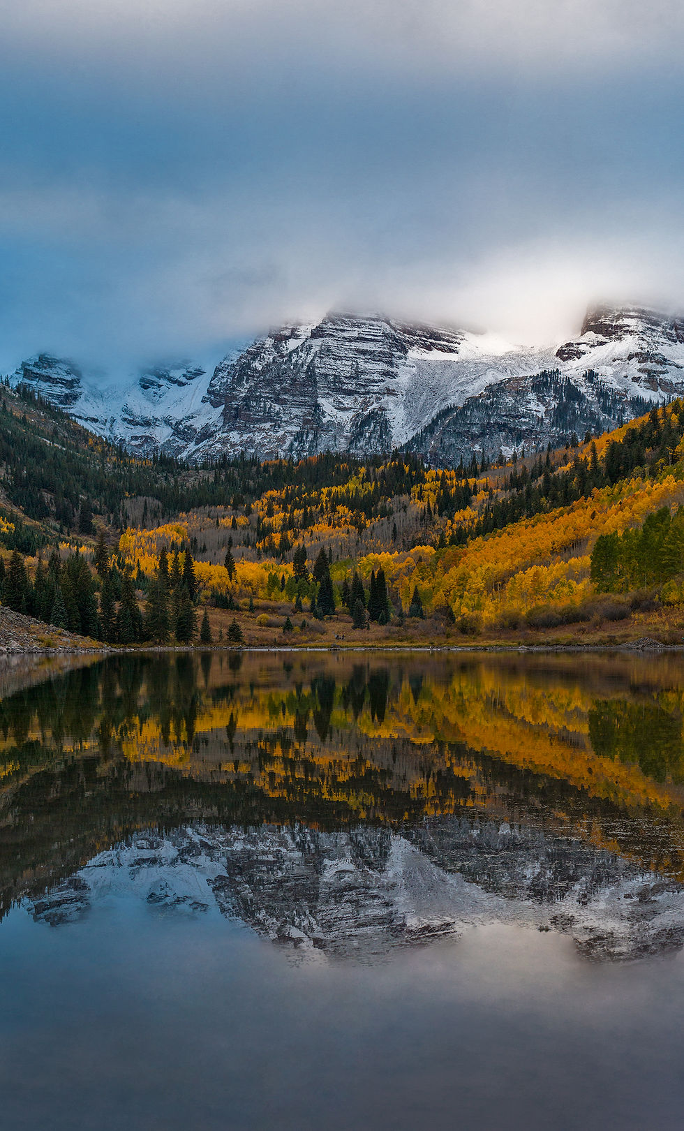 The Maroon Bells reflecting on Maroon Lake at sunrise