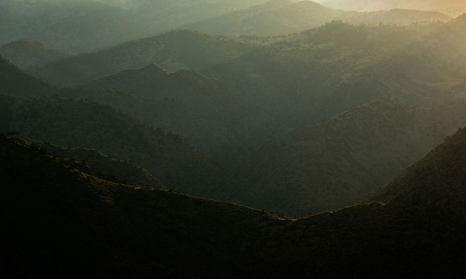 Sunlight streaming between mountain ridges.