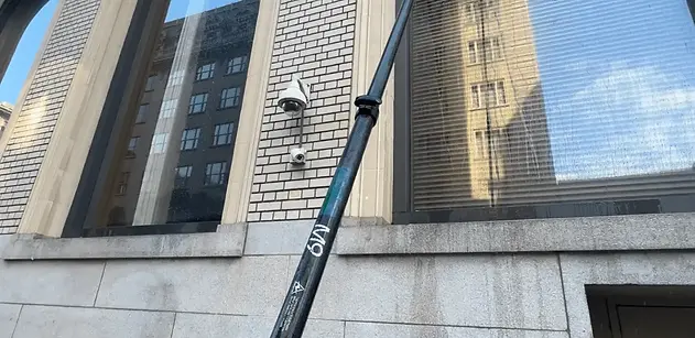 GreenCal Cleaning Crew Cleaning Windows With Telescopic Water-Fed Pole.webp