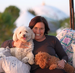 Suryalila founder Vidya with her dogs Rishi and Kumari in the pagoda.JPG